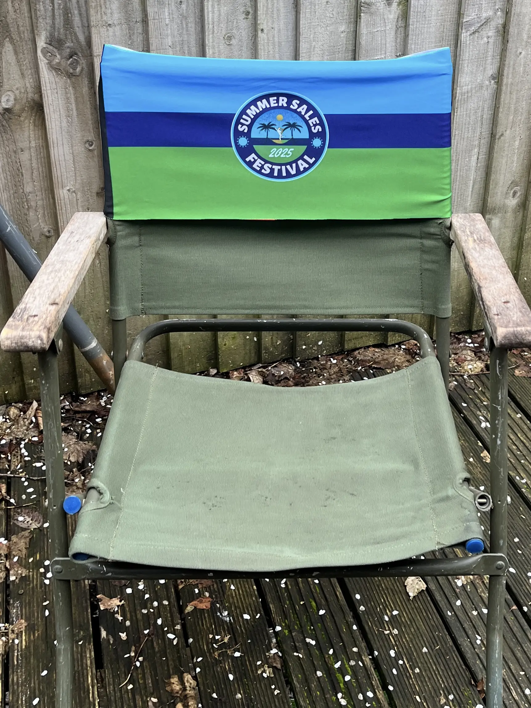 green and blue personalised tcboo band fitted to a garden chair
