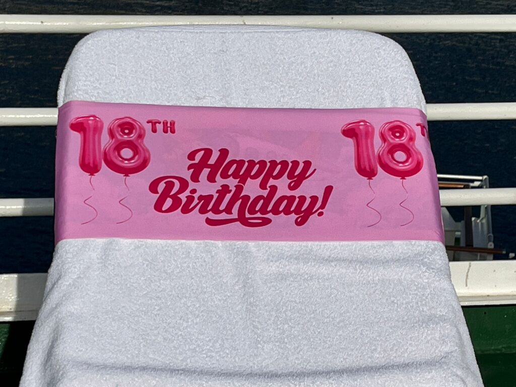 18th Birthday pink tcboo sun lounger band securing a towel to a sun lounger