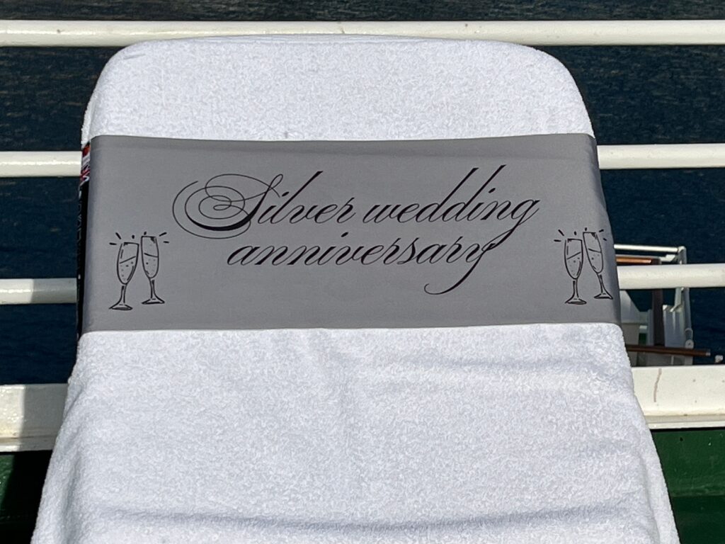 Silver Wedding Anniversary silver tcboo sun lounger band securing a towel to a sun lounger