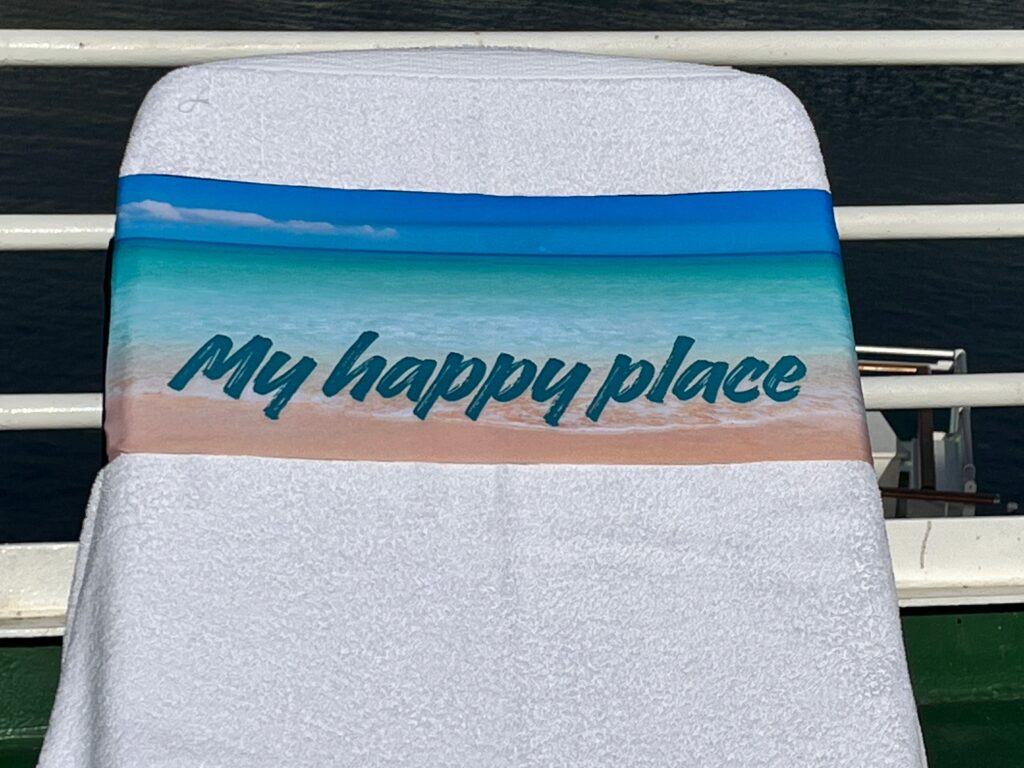 My Happy Place sky, sea and sand design on a tcboo sun lounger band securing a towel to a sun lounger