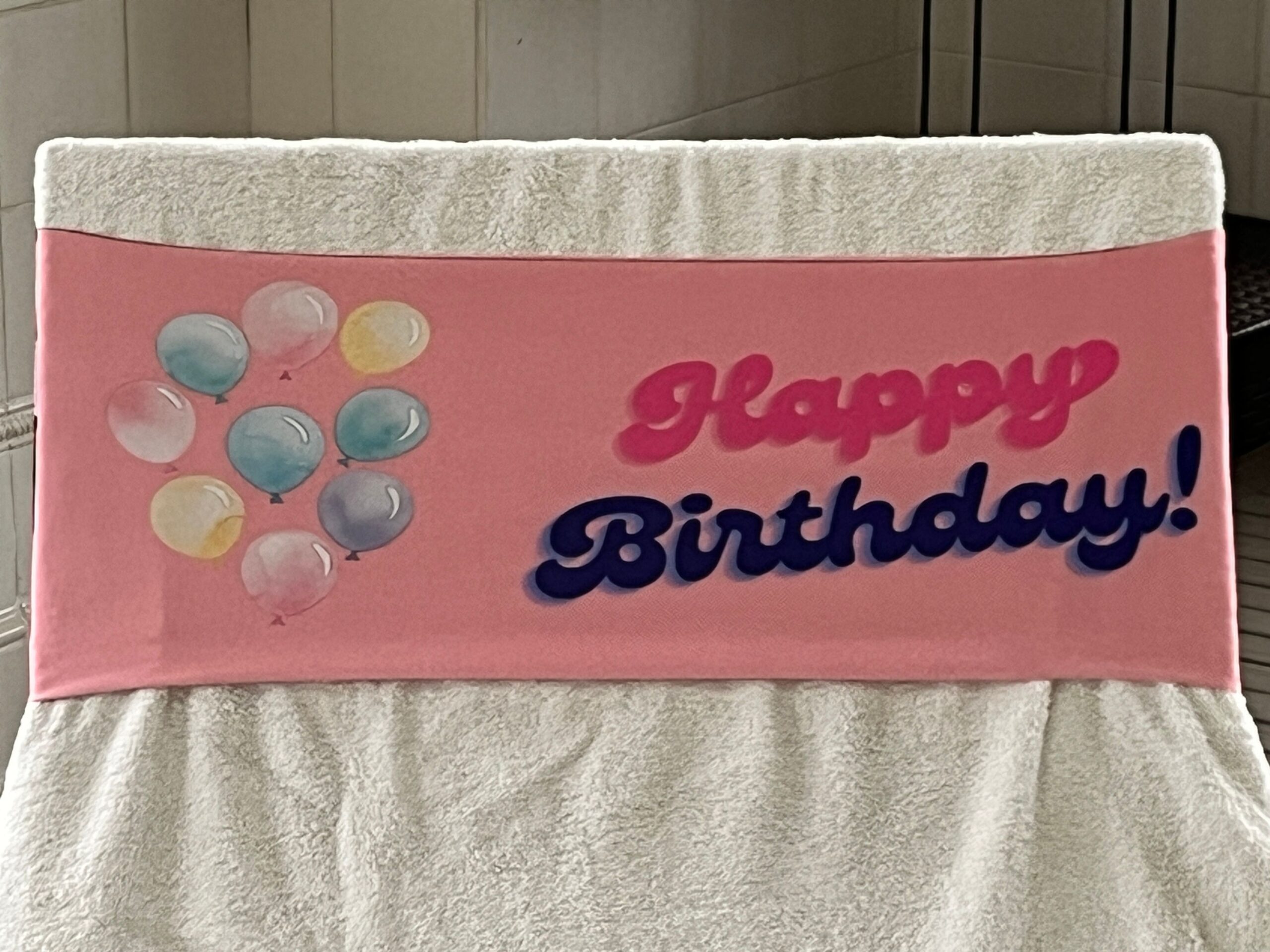 Happy Birthday design on a reusable tcboo sun lounger band