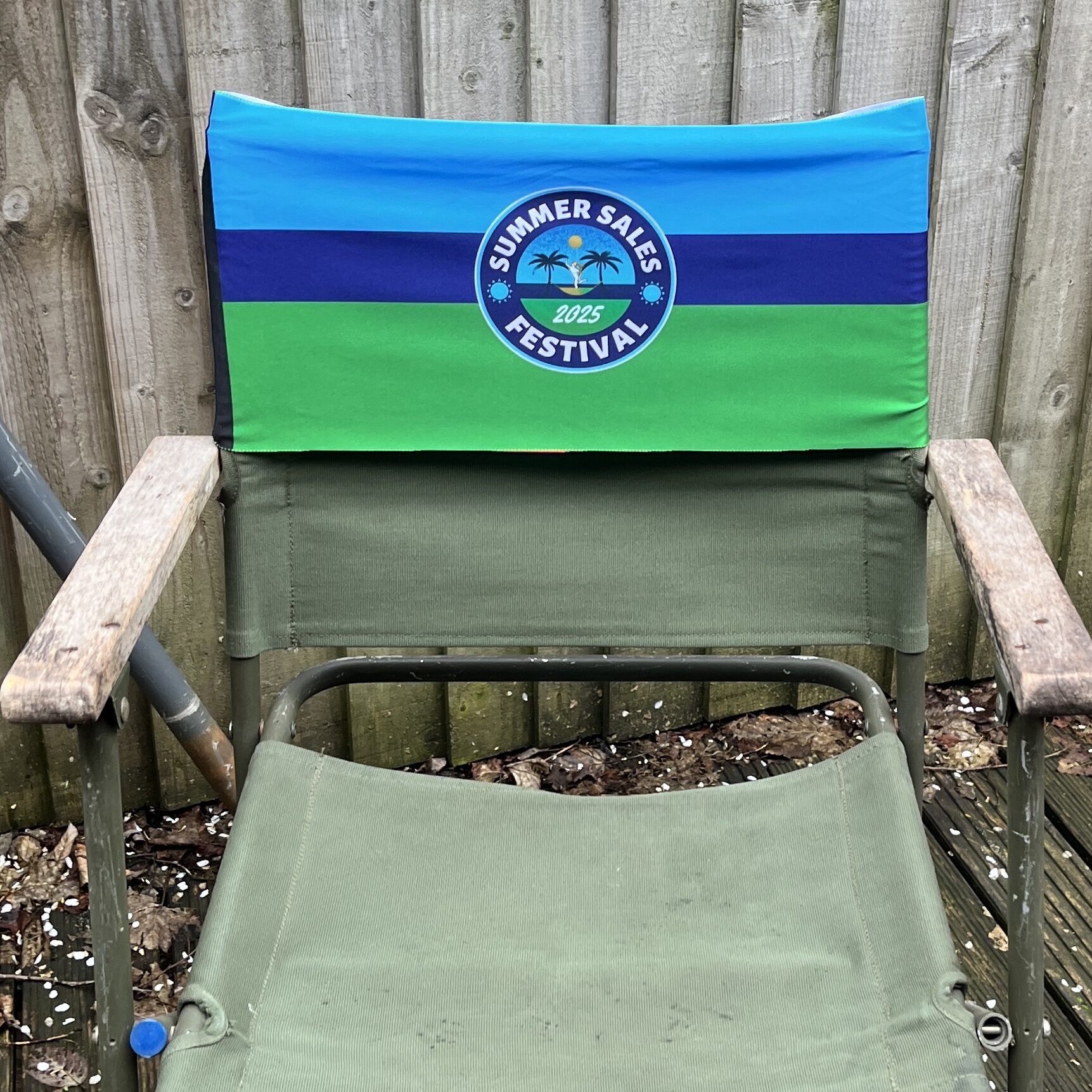 a green dark blje and light blue band on a chair depicting the Royal Signals Summer Sales Festival
