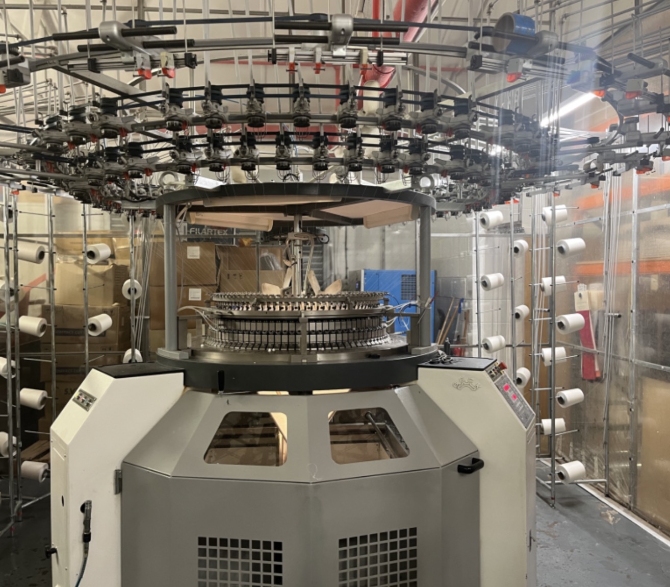 Circular knitting machine inside a textile manufacturing facility